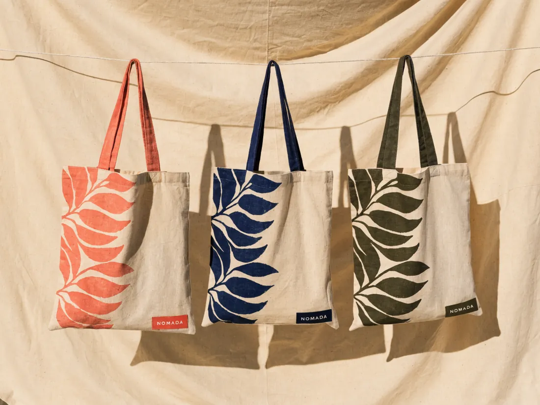 tres totes de lona con estampado botánico de hoja en coral, azul marino y olivo